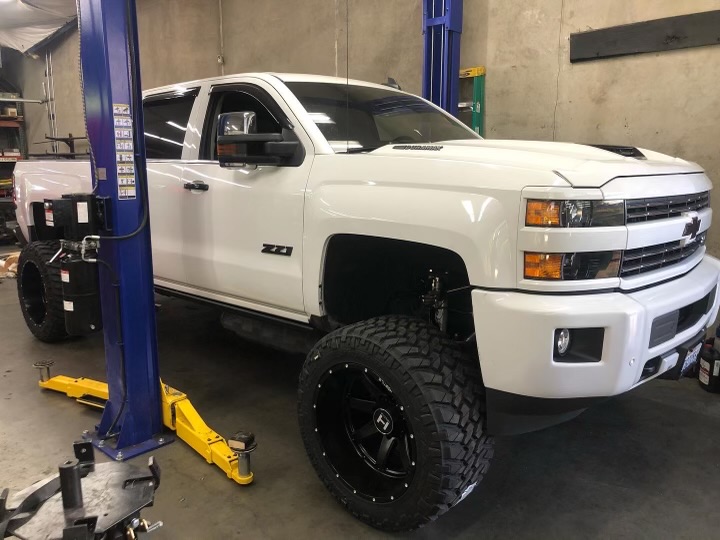 Lifted Chevy Silverado in shop